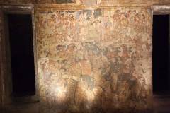 Ajanta Cave 2, hall, right wall. Vidhura, EPISODES 7, 11, 14. Episode 7 (above right): 'Having arrived in Kubera's palace on his flying horse, the Yaksha is effecting his master's permission to marry the princess of the Nagas.' Episode 11 (above left): 'The king and the Yaksha, visiting Vidhura's house, are obtaining his consent to follow the Yaksha to the kingdom of the Nagas.' Episode 14 (below): 'To celebrate Vidhura's return, a festive procession through the main street of the city is organised, complete with elephants, men on horses and warriors, in which Vidhura rides on the king's right side.'  (#37, Schlingloff 2013, vol. I, 166-68)